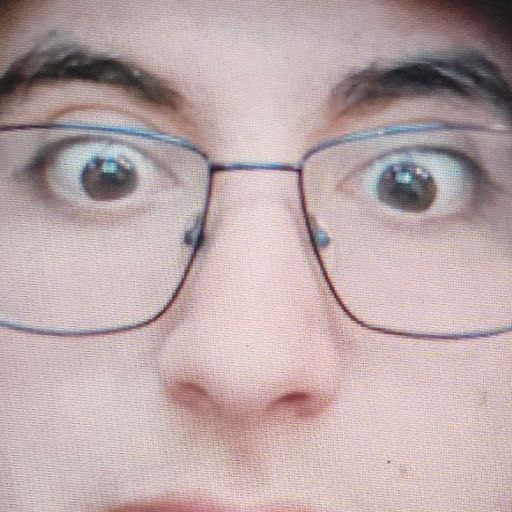 Extreme close-up of my face, eyes wide behind glasses
